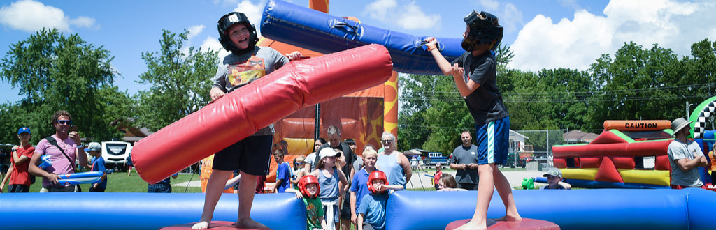 kids play fighting on blow up festival event 