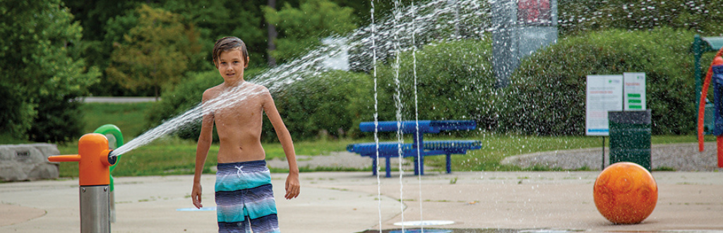 kid in splash pad