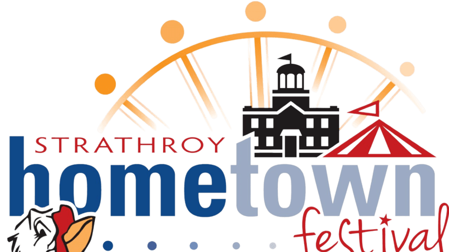 Logo for the Strathroy Hometown Festival featuring a stylized town hall building, a red circus tent, sunrise rays, and a rooster illustration, with the text “Strathroy hometown festival – Welcome Home.