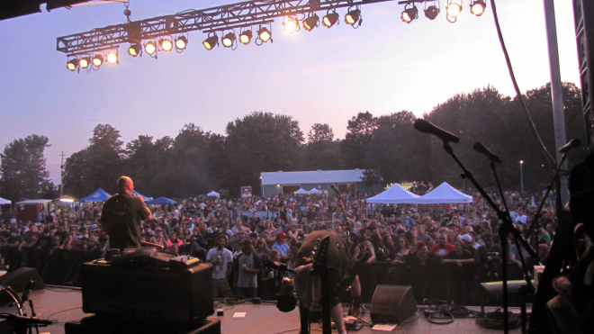 concert stage with a huge crowd of people 