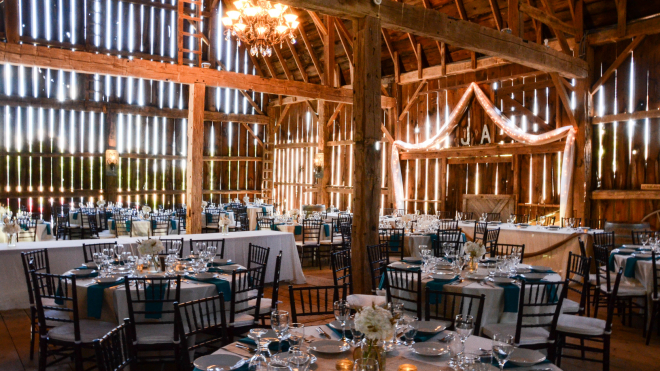 Venue set up with tables and chairs and string lights 