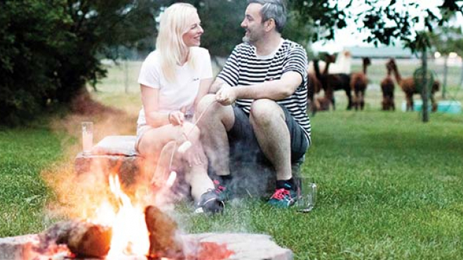 couple in front of a campfire 