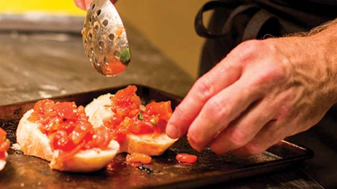 man preparing bruschetta