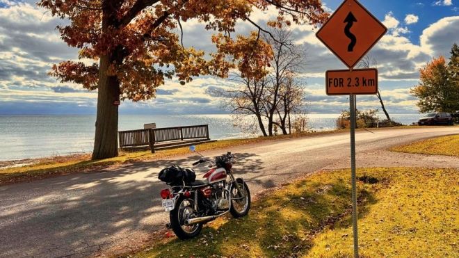 Two motorcycles by a lake