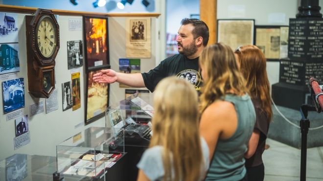 curator showing visitors artifacts