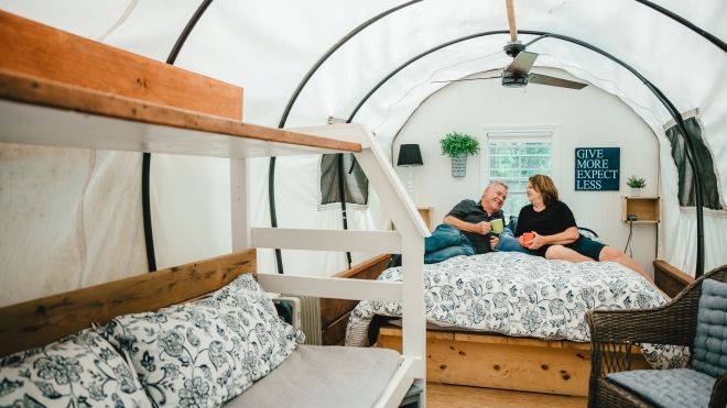 couple relaxing in covered wagon