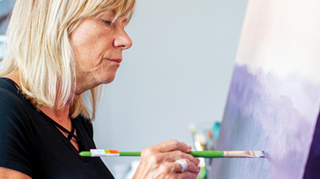 woman painting on a canvas 