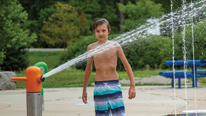 Little boy playing in a splash pad