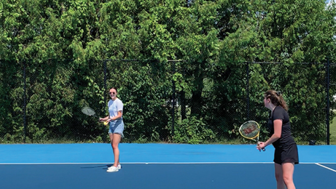 two women playing tennis 