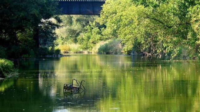 the ausable river body of water surrounded by greenery