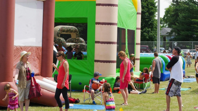 people in front of bouncy castles