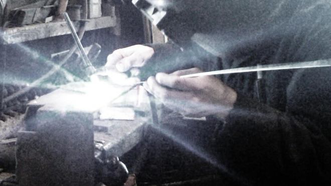 a man welding in a shop 