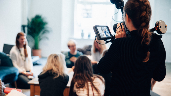 Woman with camera at a press conference