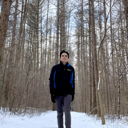 Paul walking through snow and trees