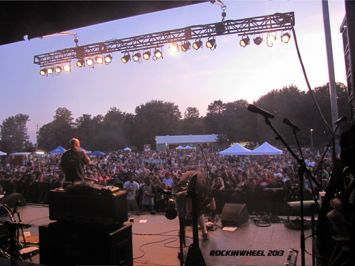 concert stage with a huge crowd of people 