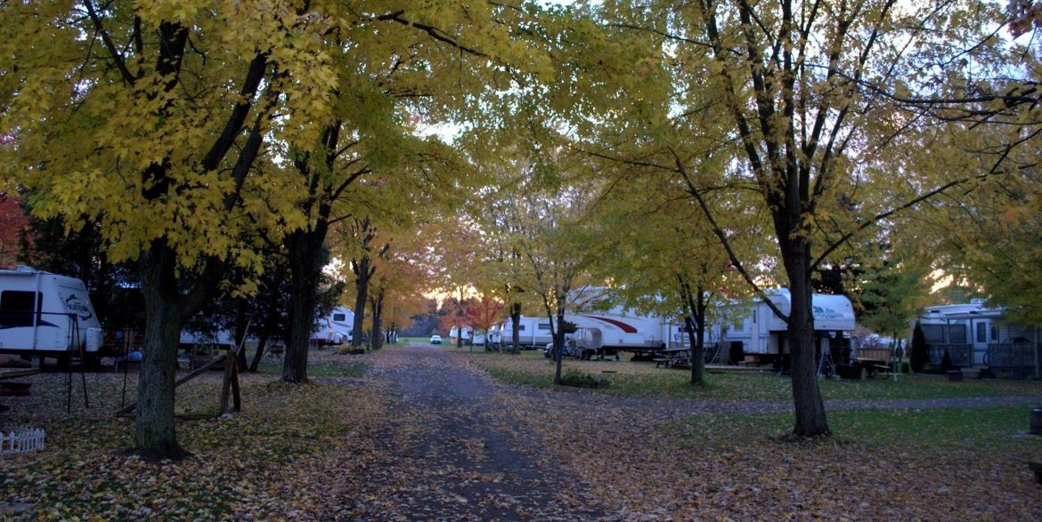 A campground full of trailers, during an autumn sunset