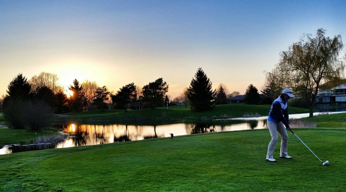 a man hitting a ball at Pine Knot at sunset