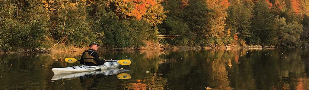 Man canoeing in the fall