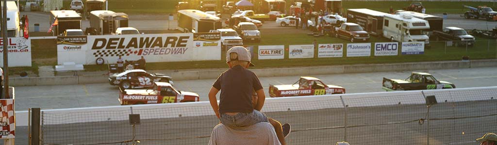 Father and son watching race cars 