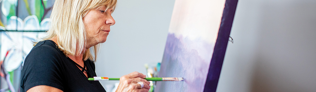 woman painting on a canvas 