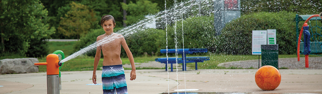 Little boy playing in a splash pad