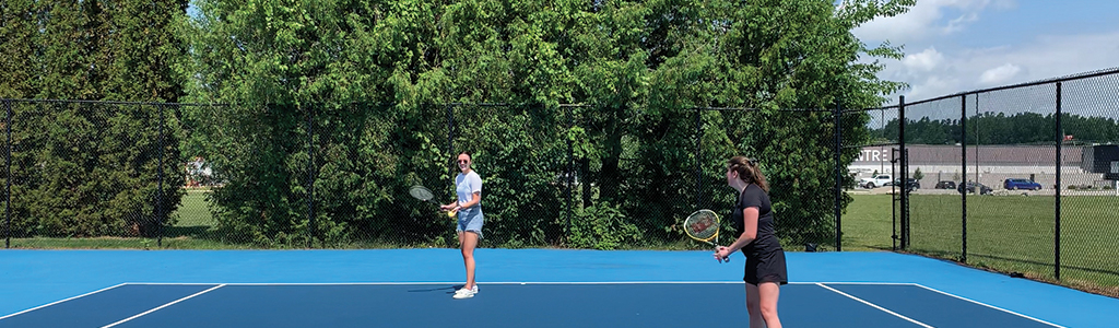 two women playing tennis 