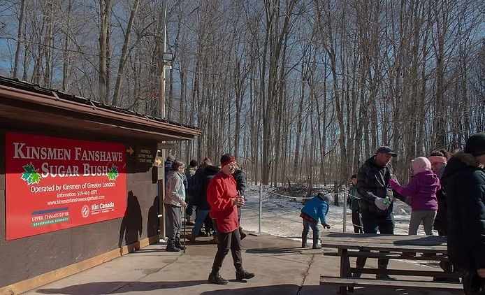 A sunny and busy day in the sugar bush, with many families congregated around the Kinsmen CLub sign