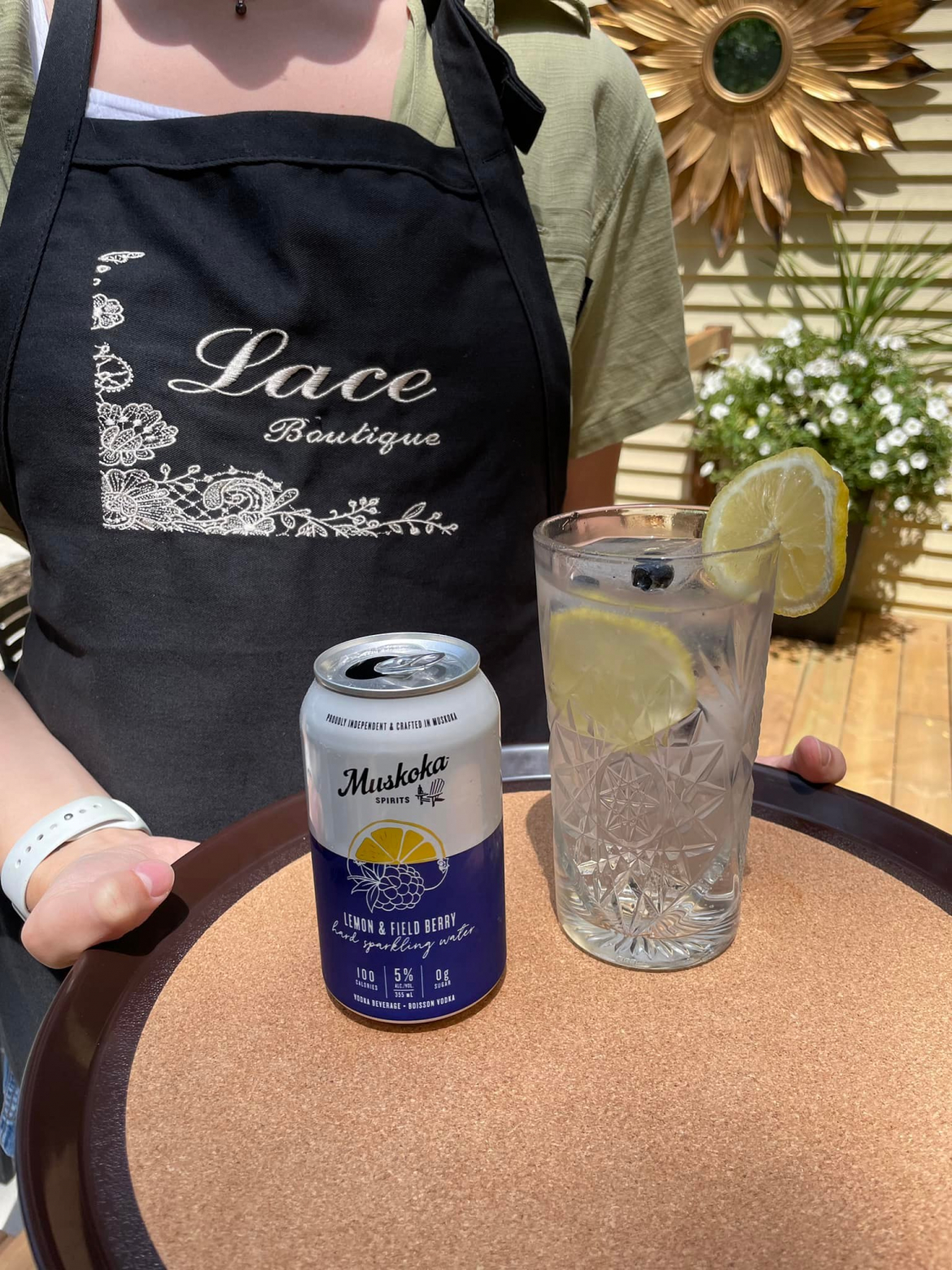 lace boutique apron with two drinks infront 