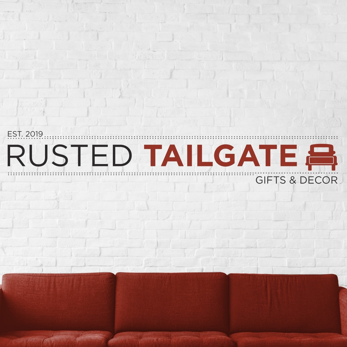 rusted tailgat wall sign with red truck graphic beside it over a auburn coloured couch
