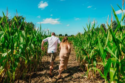kids running through a corn maze 